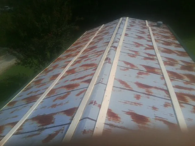 Rusted metal roof panels with new wood purlins before replacement — Storm Damage Roof Repair in Delavan by Roofing Brothers