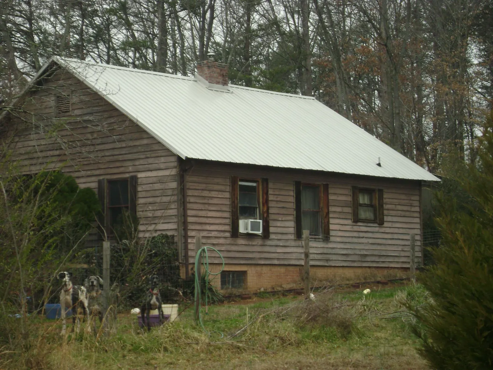White metal roof on an old wood sided farmhouse, from a Metal Roof Installation job in Delavan